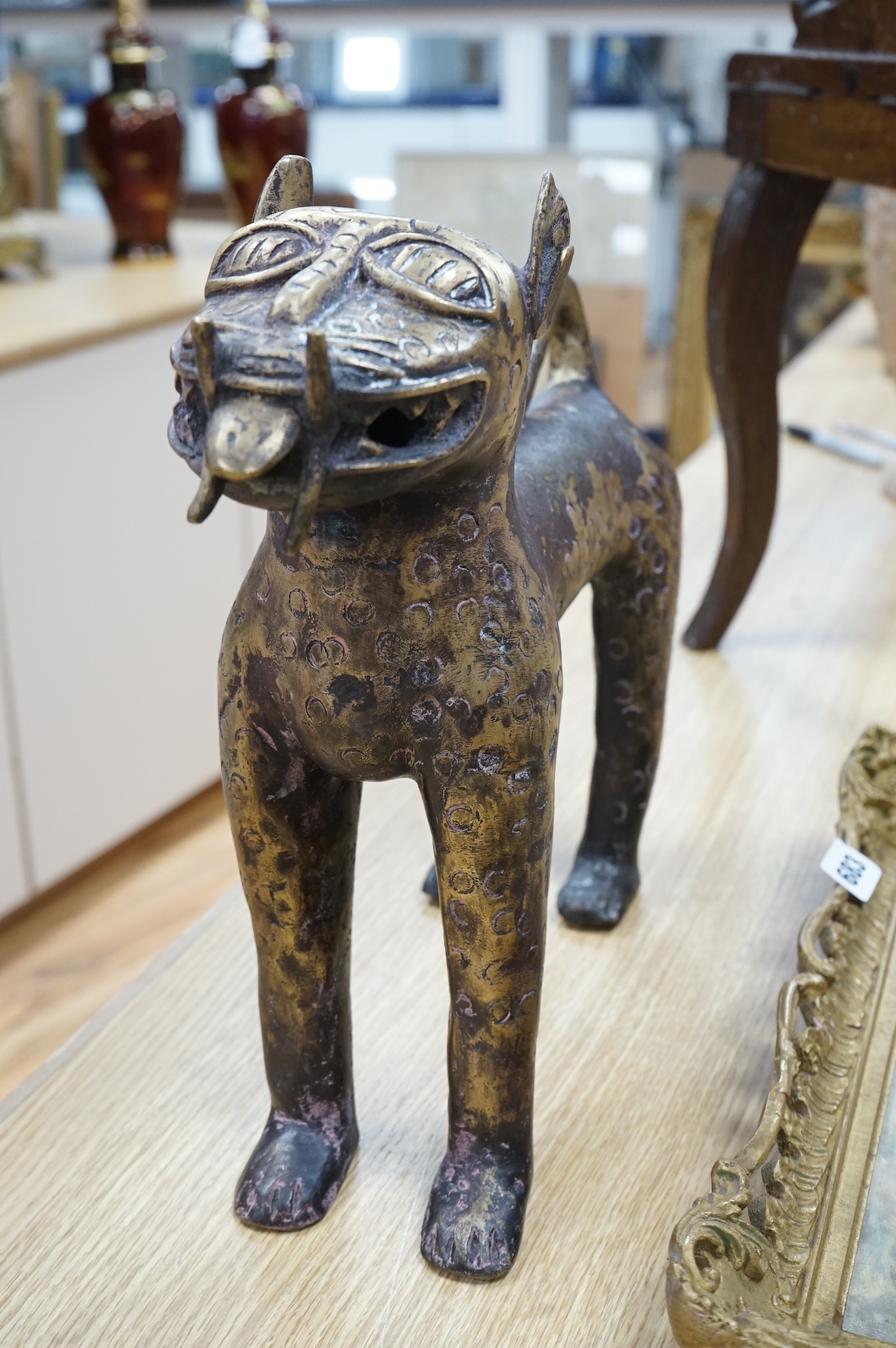 An African Benin style bronze model of a leopard, 37cm x 33cm